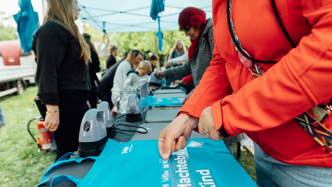 Besucherinnen beschriften Beutel auf der Grünen Messe