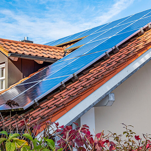 Photovoltaikanlage auf einem roten Satteldach mit Gaube