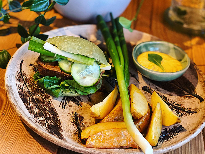 vegetarischer Burger mit Kartoffelspalten auf einem Teller