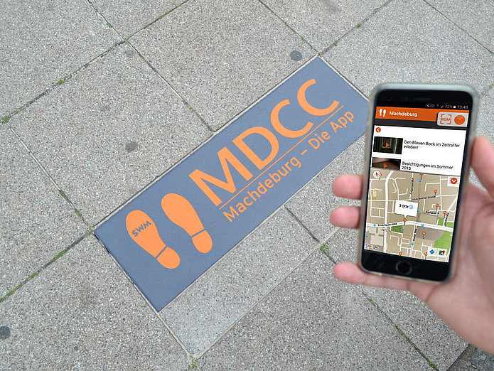 MDCC Tapse mit einem Screenshot der MDCC Machdeburg App